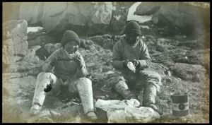 Image of Two Polar Eskimos [Inughuit] Eating Raw Birds